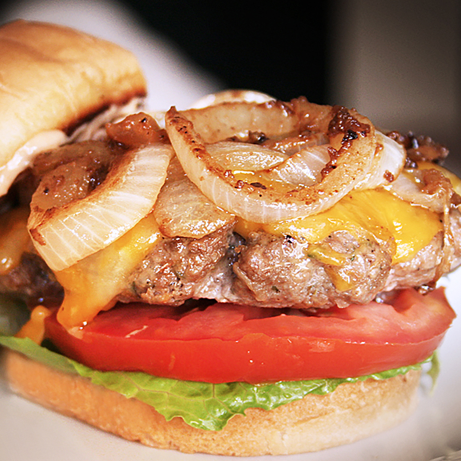 A delicious hamburger topped with caramelized onions